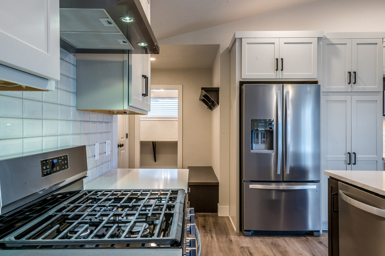 White shaker kitchen with stainless appliances